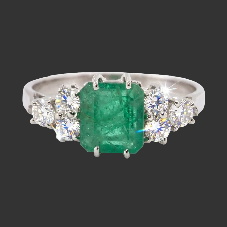 A fine white gold* ring that features a rectangular emerald centre stone, measures 6x6.5mm (est one carat),