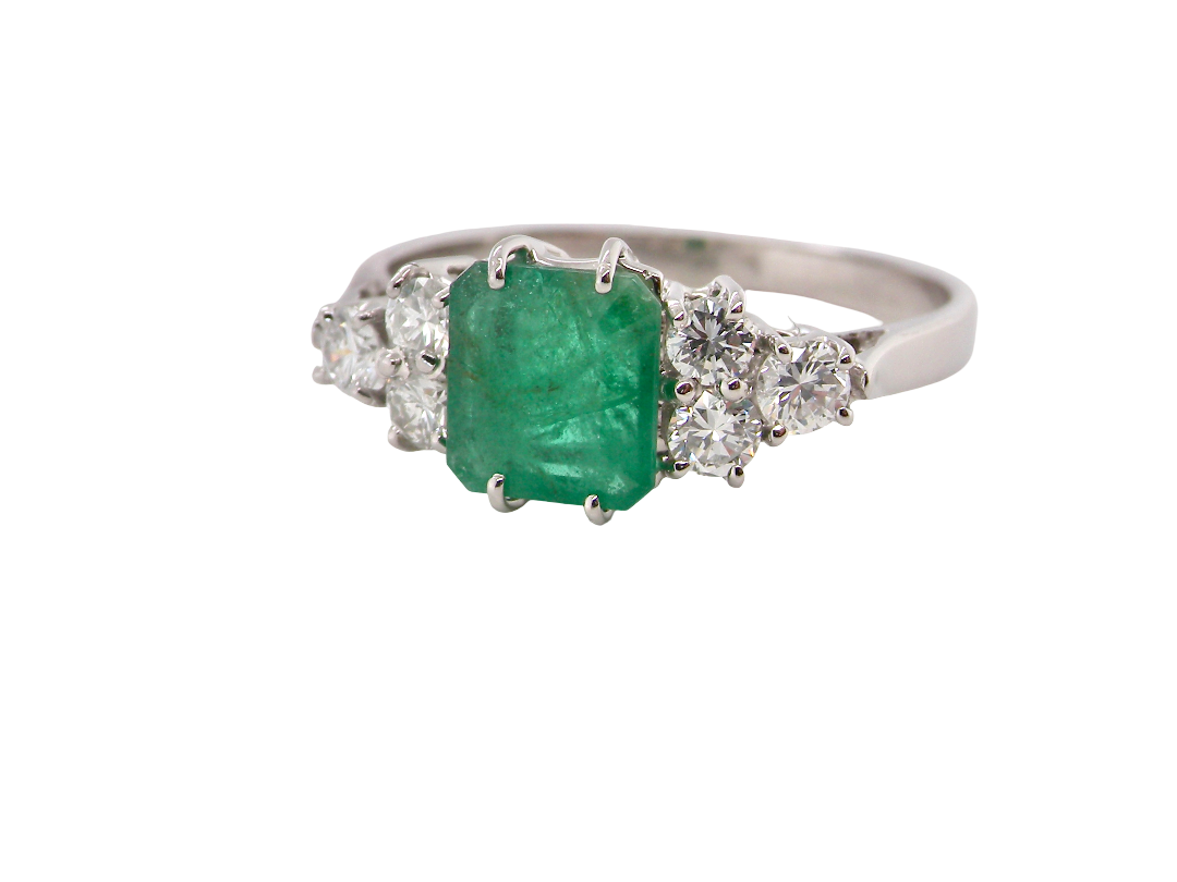 A fine white gold* ring that features a rectangular emerald centre stone, measures 6x6.5mm (est one carat), mid to dark green hue,