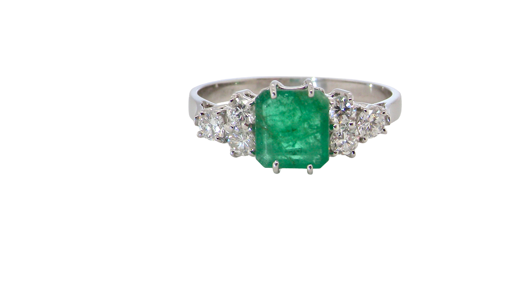 A fine white gold* ring that features a rectangular emerald centre stone, measures 6x6.5mm (est one carat), mid to dark green hue, natural inclusions as with most emeralds.