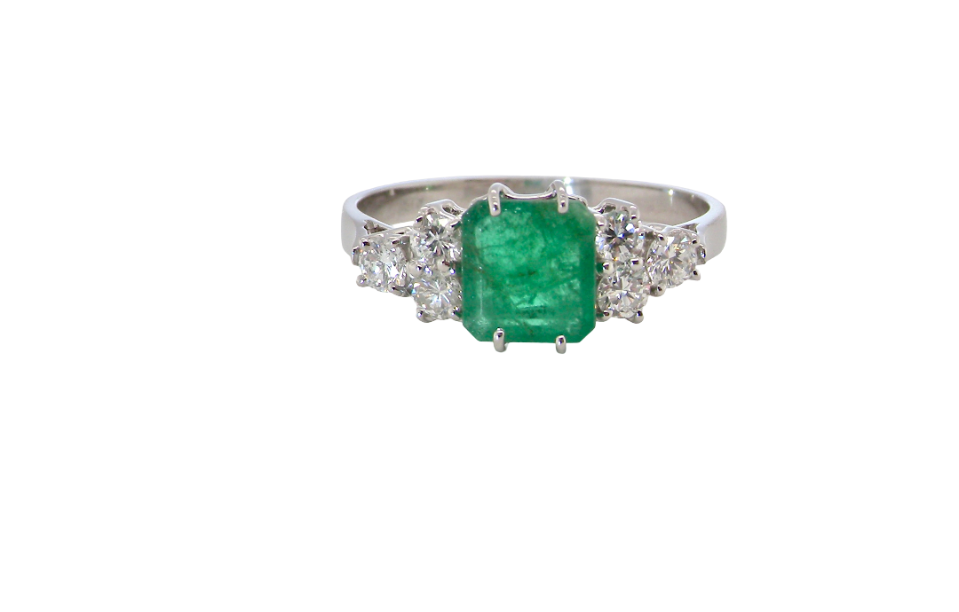 A fine white gold* ring that features a rectangular emerald centre stone, measures 6x6.5mm (est one carat), mid to dark green hue, natural inclusions as with most emeralds.