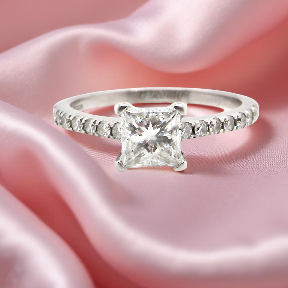 Diamond ring on pink satin fabric