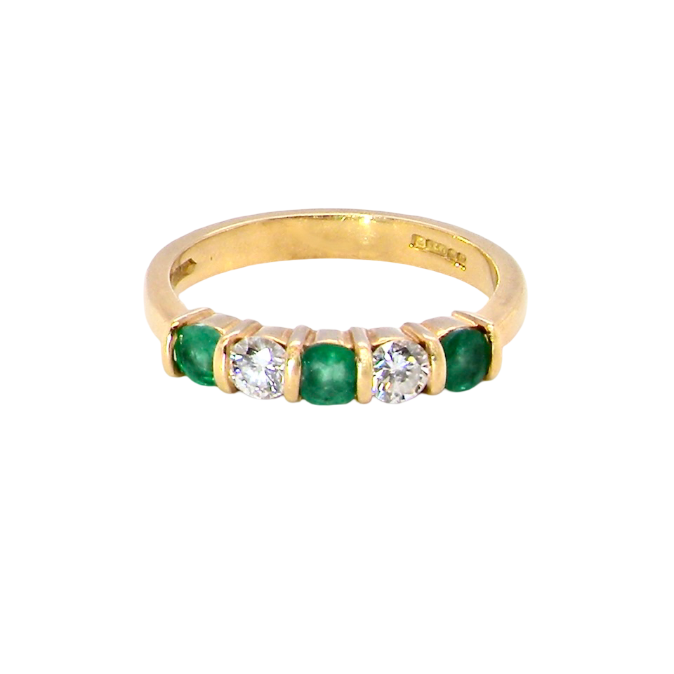 A five stone ring set with three emeralds, each 3mm diameter.
Between each two brilliant cut white diamonds, each 3.4mm (0.15 carats each est), colour i-j, clarity Si.
