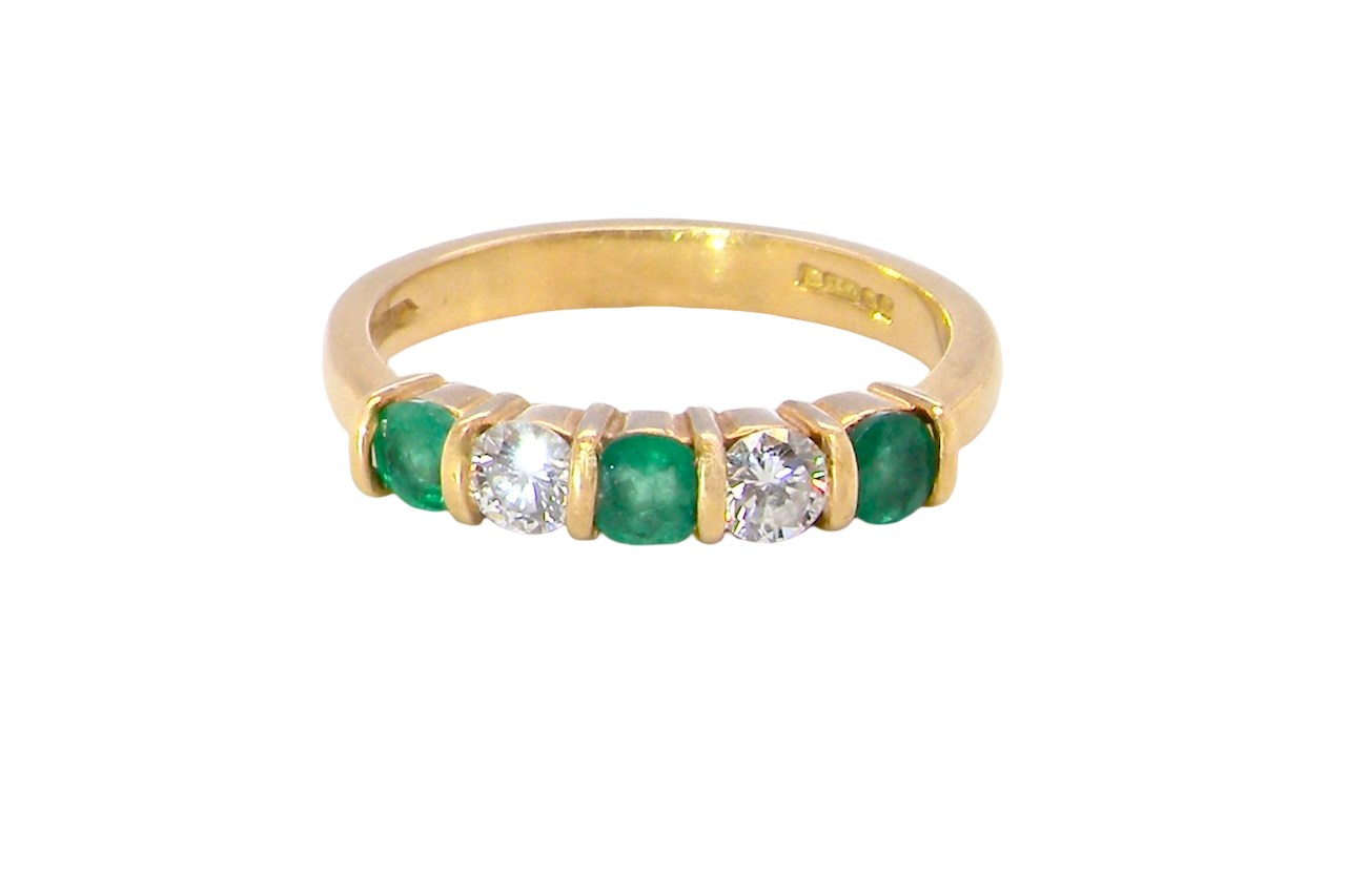 A five stone ring set with three emeralds, each 3mm diameter.
Between each two brilliant cut white diamonds, each 3.4mm (