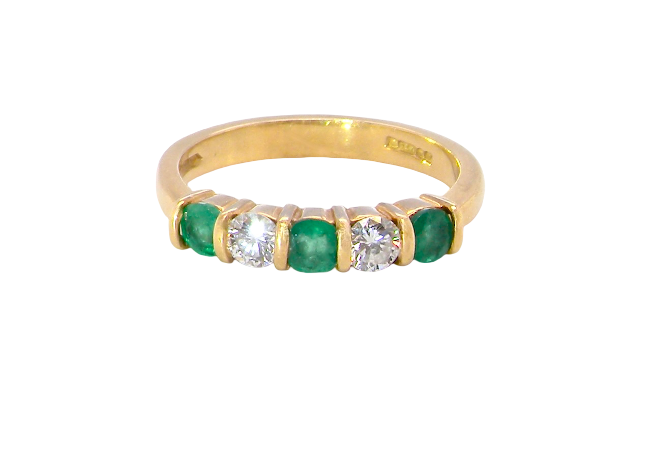 A five stone ring set with three emeralds, each 3mm diameter.
Between each two brilliant cut white diamonds, each 3.4mm (