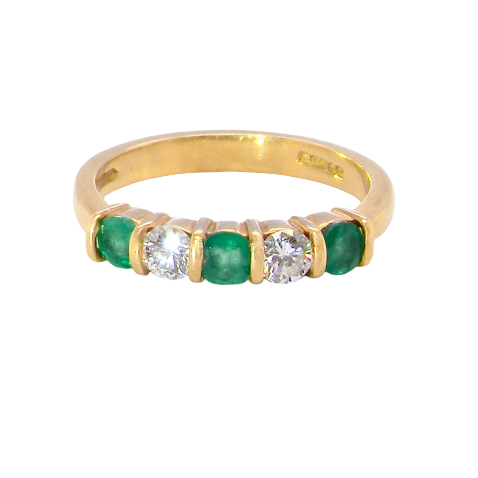 A five stone ring set with three emeralds, each 3mm diameter.
Between each two brilliant cut white diamonds, each 3.4mm (