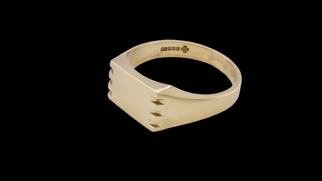 A gentleman's 9 carat gold signet ring. Rectangular shaped head,