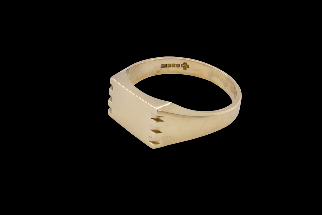 A gentleman's 9 carat gold signet ring. Rectangular shaped head,