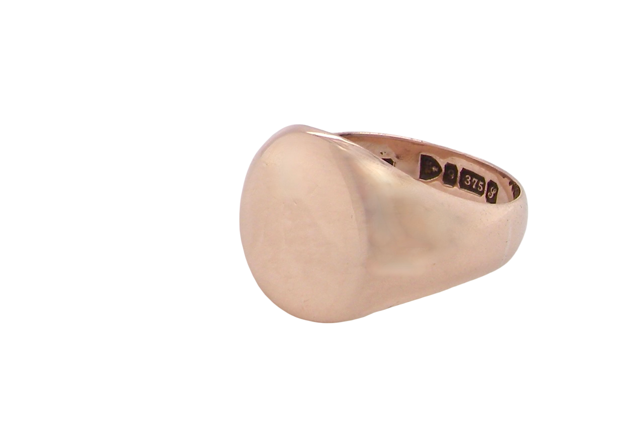 A gentleman's 9 carat rose gold signet ring. The head is oval shaped 13x13mm, totally plain with a seamless surface to the shoulders.