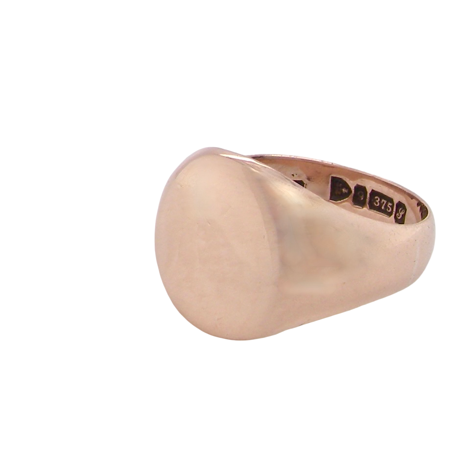 A gentleman's 9 carat rose gold signet ring. The head is oval shaped 13x13mm, totally plain with a seamless surface to the shoulders.