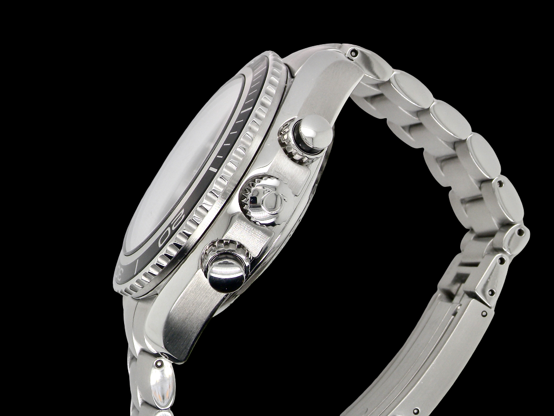Close-up side profile of a silver stainless steel watch with a matching metal link bracelet, featuring a textured bezel, crown, and pushers against a solid black background.