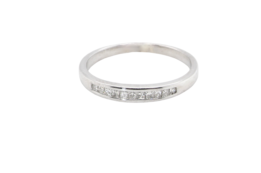 A half hoop 9 carat white gold eternity ring.
Channel set with 11 Princess cut white diamonds,