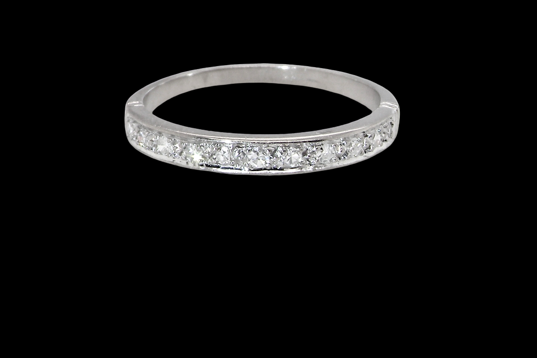 A half hoop eternity ring. Set with eleven small white diamonds, brilliant cut 2mm each (total est 0.33 carats)