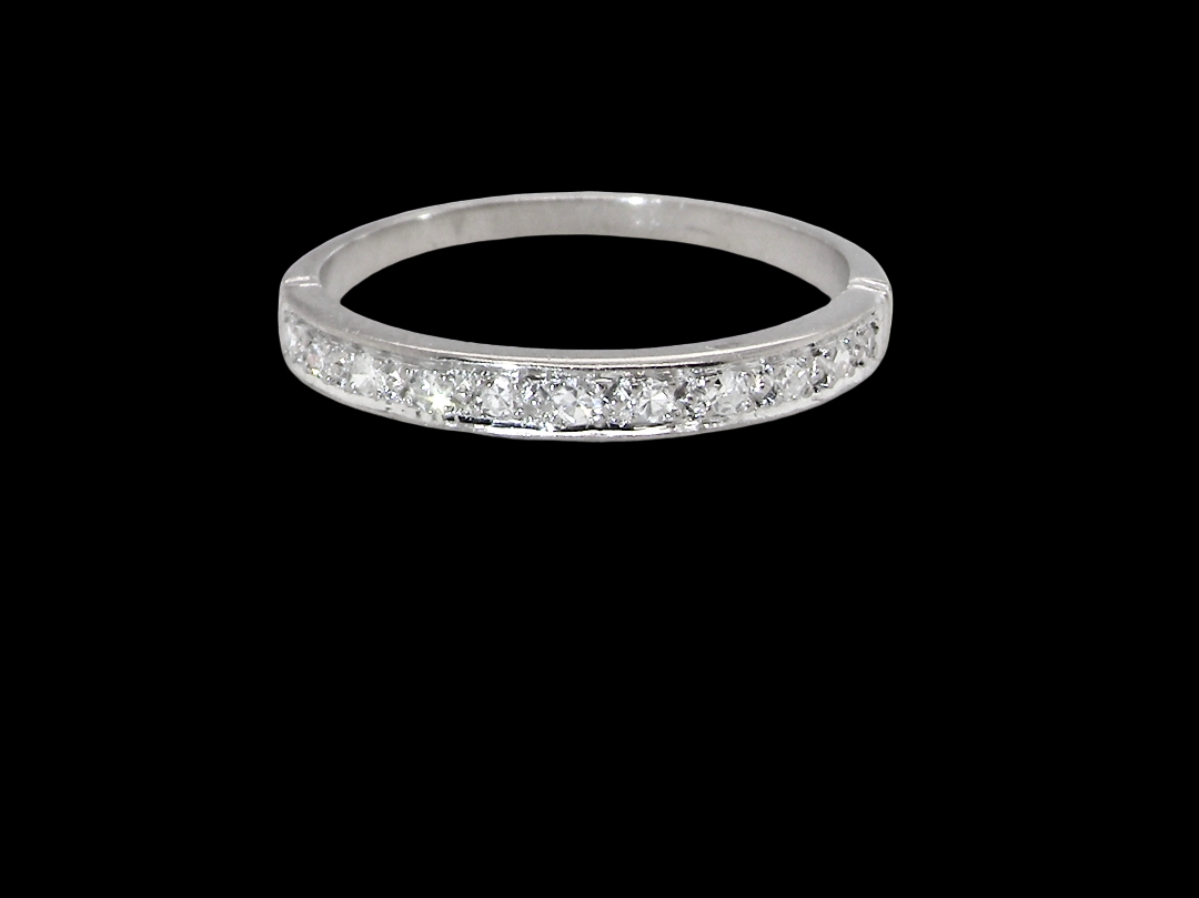 A half hoop eternity ring. Set with eleven small white diamonds, brilliant cut 2mm each (total est 0.33 carats)