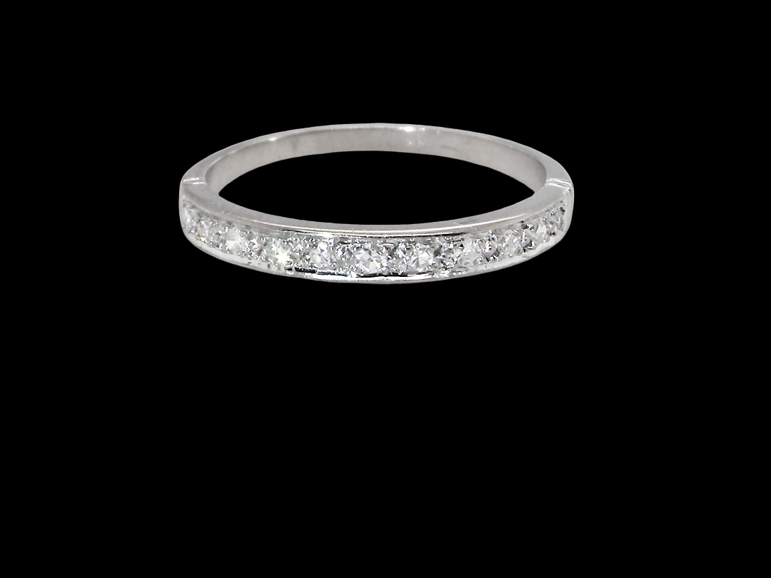 A half hoop eternity ring. Set with eleven small white diamonds, brilliant cut 2mm each (total est 0.33 carats)