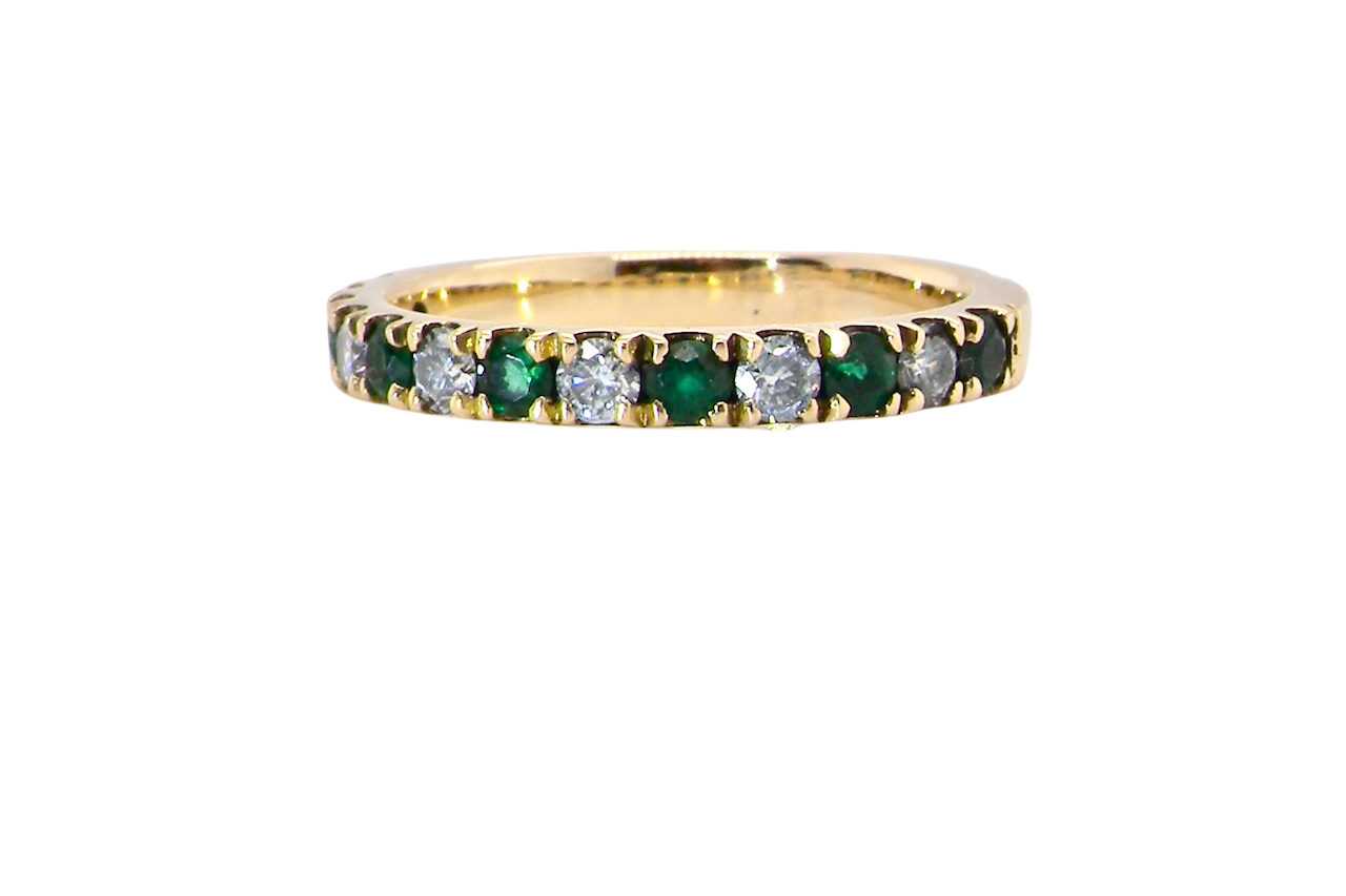 A half hoop eternity ring. Set with seven emeralds,A