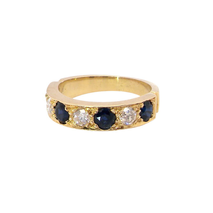 A half hoop ring. Features four dark ink blue black sapphires, each 3.6mm, and three brilliant cut white diamonds, each 3.6mm (est 0.15-0.17 carats each, total 0.50 carats est)