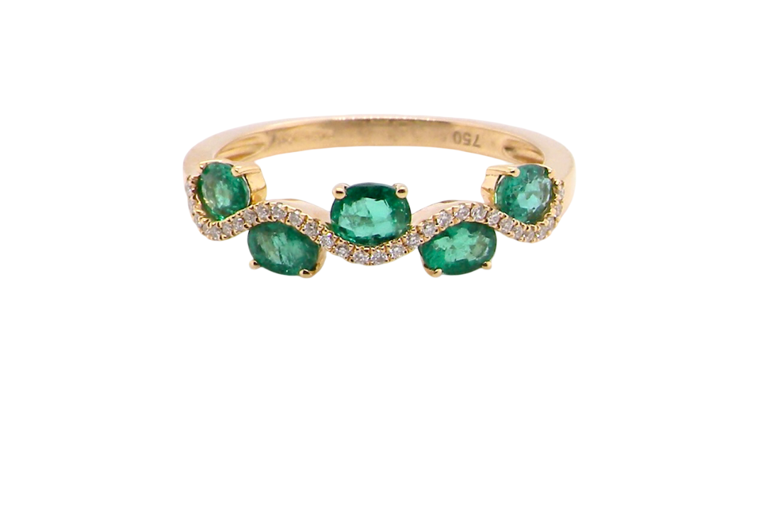 A half hoop ring with a very attractive line of oval cut emeralds, each 4x3mm, a lovely deep grass green hue, and with very good clarity too.