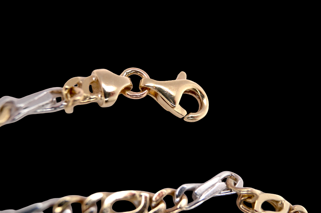 Figaro A heavy 9 carat gold neck chain. Two colour gold, white and yellow