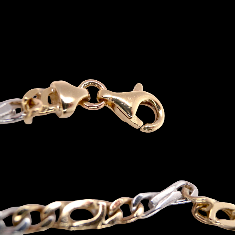 Figaro A heavy 9 carat gold neck chain. Two colour gold, white and yellow