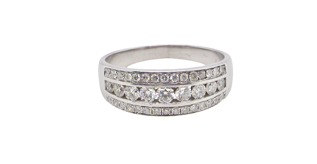 A lovely 18 carat white gold half hoop ring. Set with a middle row of nine bright white brilliant cut diamonds, graduate from 2.2mm to 2.6mm. The top and bottom rows are also set with small diamonds.