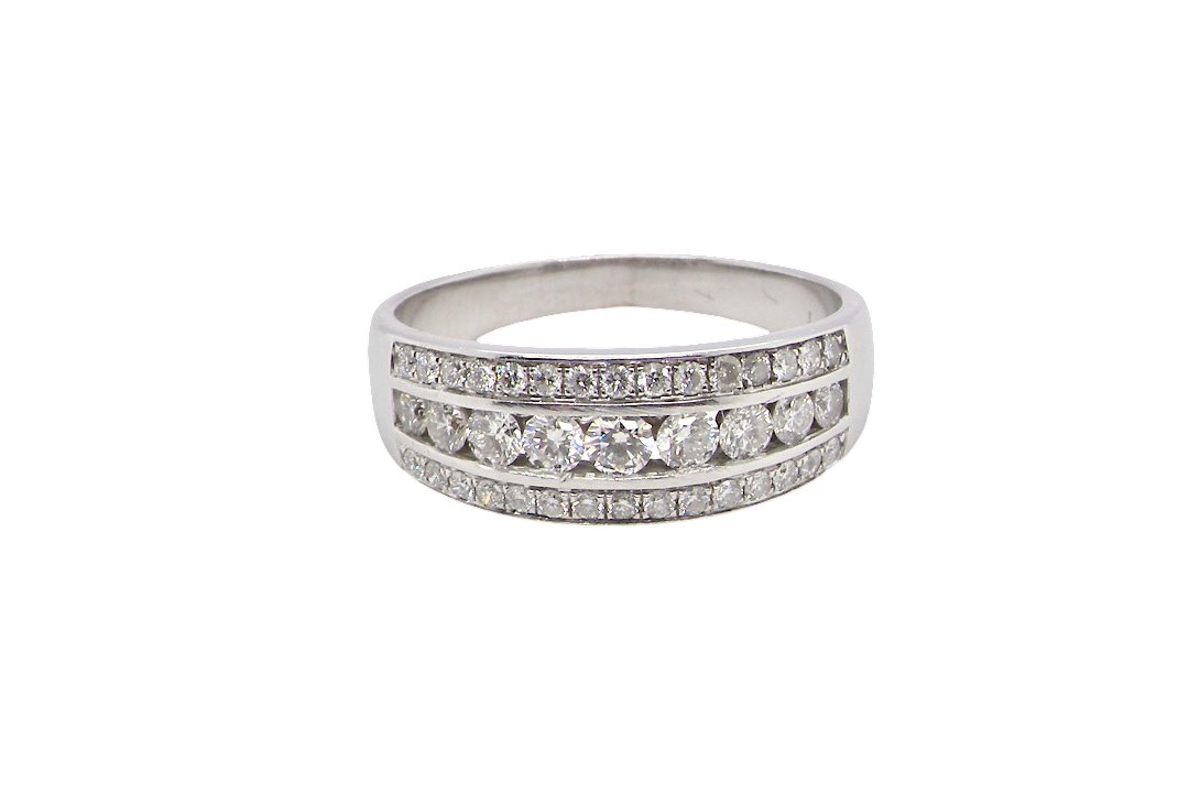A lovely 18 carat white gold half hoop ring. Set with a middle row of nine bright white brilliant cut diamonds, graduate from 2.2mm to 2.6mm. The top and bottom rows are also set with small diamonds.