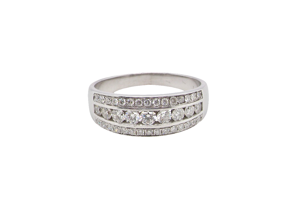 A lovely 18 carat white gold half hoop ring. Set with a middle row of nine bright white brilliant cut diamonds, graduate from 2.2mm to 2.6mm. The top and bottom rows are also set with small diamonds.