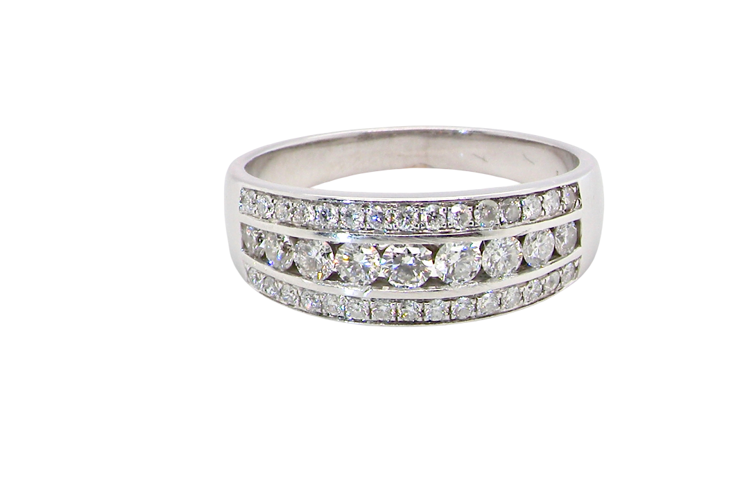 A lovely 18 carat white gold half hoop ring. Set with a middle row of nine bright white brilliant cut diamonds, graduate from 2.2mm to 2.6mm. The top and bottom rows set with small diamonds.