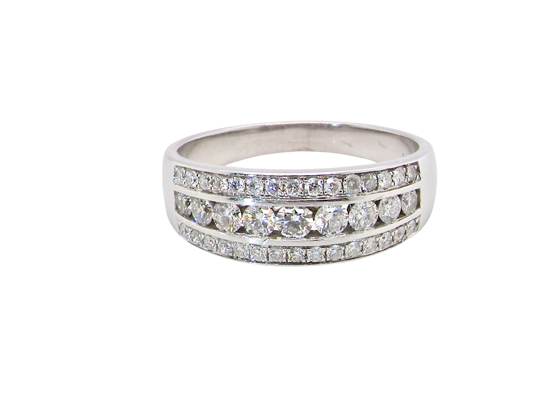 A lovely 18 carat white gold half hoop ring. Set with a middle row of nine bright white brilliant cut diamonds, graduate from 2.2mm to 2.6mm. The top and bottom rows set with small diamonds.