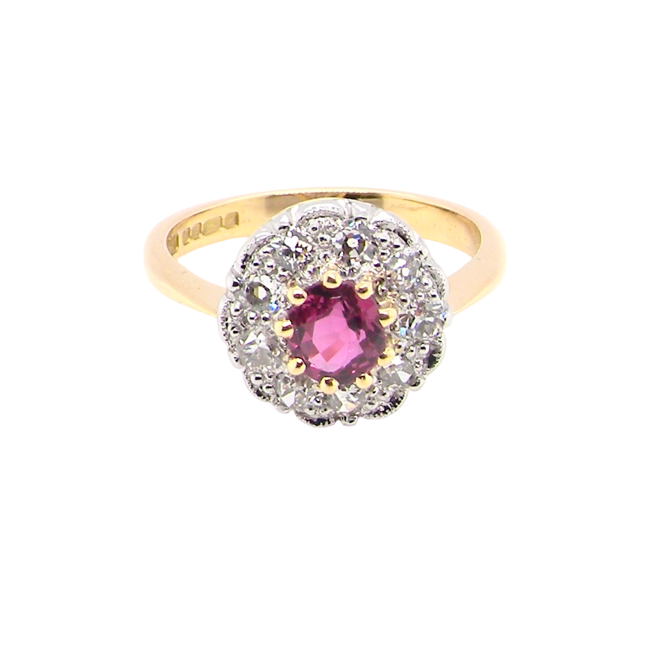 A lovely daisy cluster ring that profiles to the centre a deep red ruby, 5mm (0.50 carats) yellow claw set.