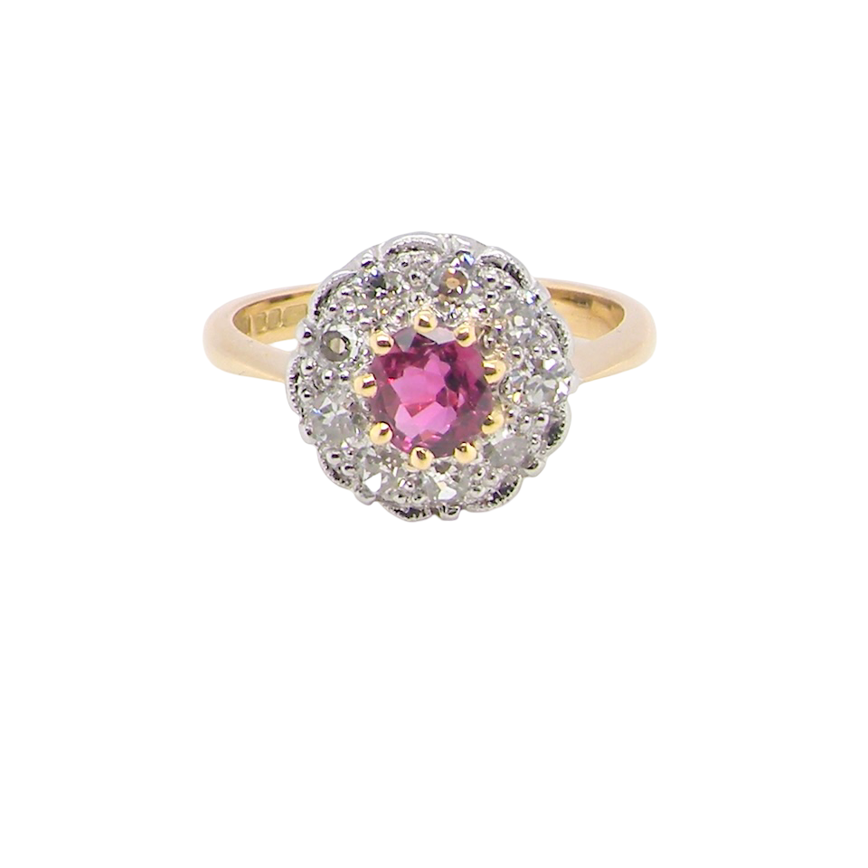 A lovely daisy cluster ring that profiles to the centre a deep red ruby, 5mm yellow claw set.