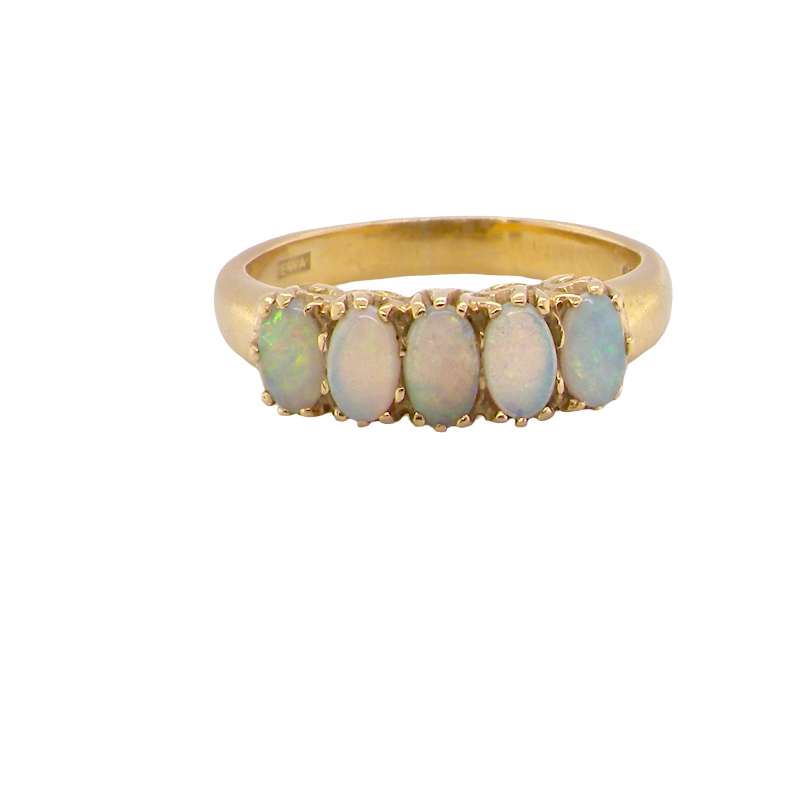 A lovely five stone ring. Set with five oval white opals, each 5x3.5mm, good play of colour on all.
Carved head