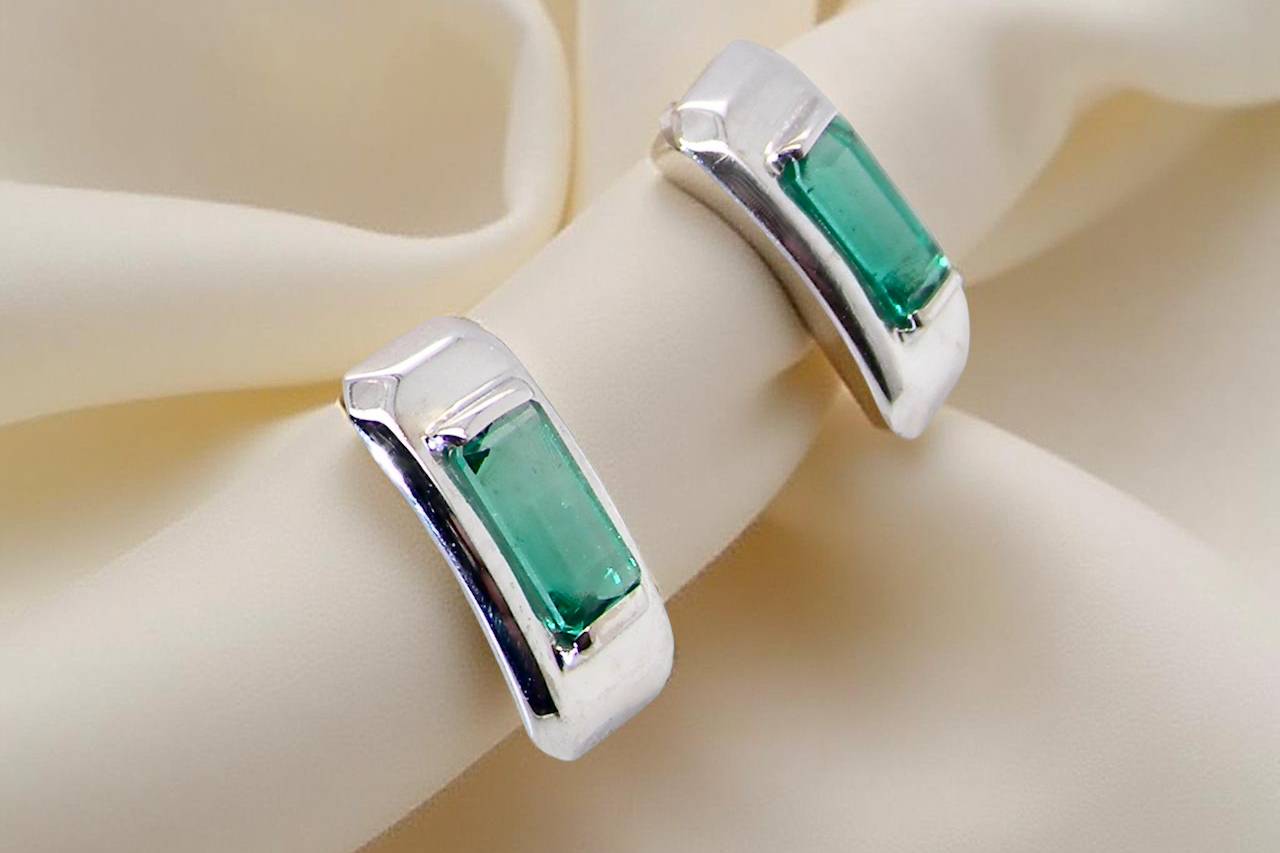 A lovely modern pair of earrings. Each emerald is rectangular,