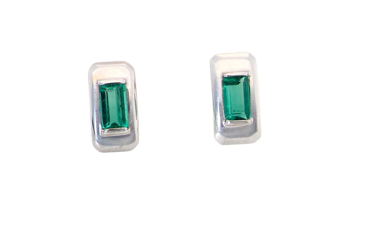A lovely modern pair of earrings. Each emerald is rectangular, step cut,