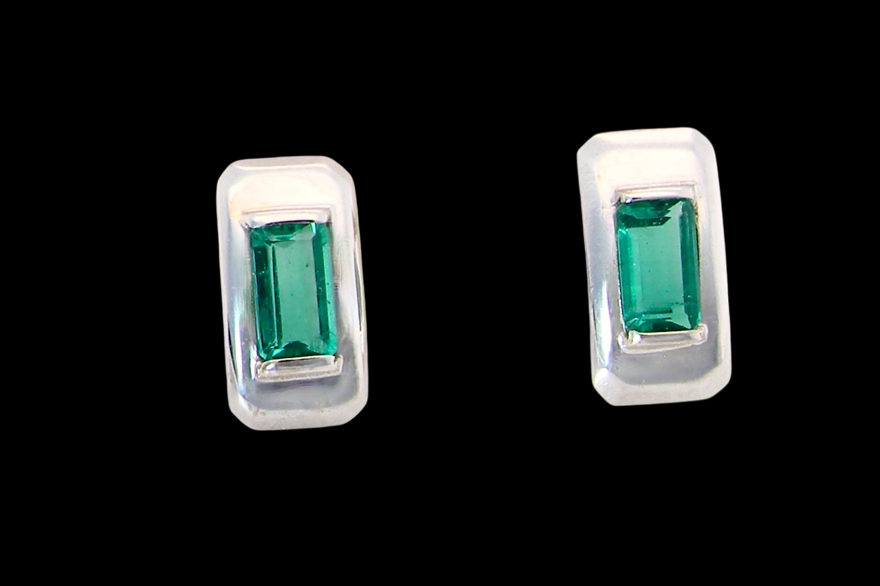 A lovely modern pair of earrings. emerald is rectangular, step cut,