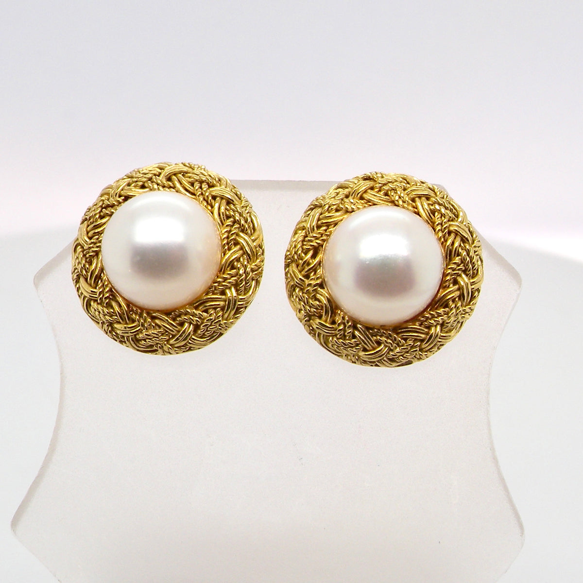 A lovely pair of elegant earrings, each set with a 7.7 mm cultured pearl.
