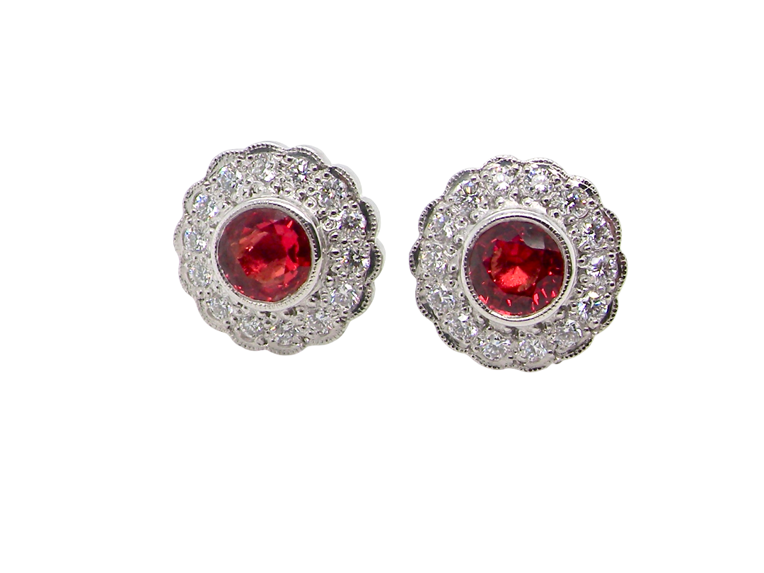 A lovely pair of stud earrings. Each features an unusual colour sapphire, fireglow orange. A deep orange hue, measures 5mm