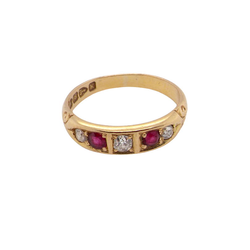 A vintage yellow gold ring featuring a row of round-cut pinkish-red rubies and clear diamonds, shown on a plain white background.