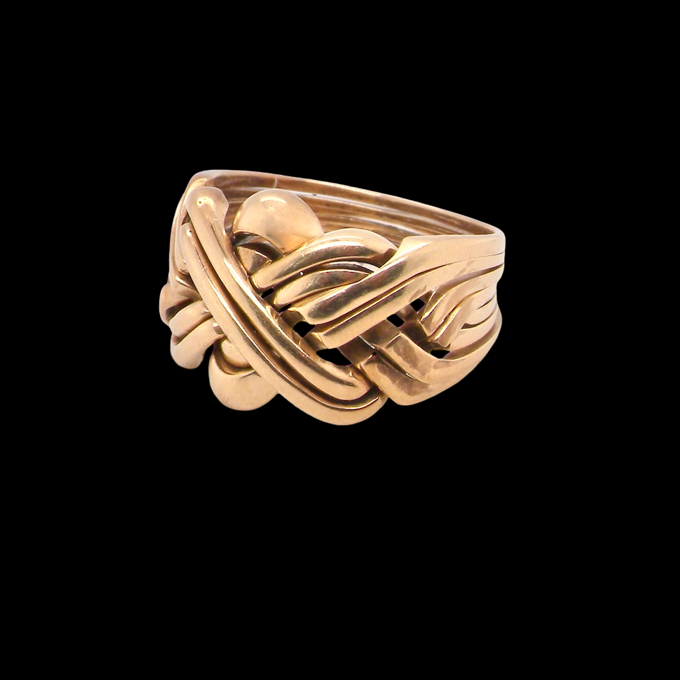 Gold ring with a unique design on a black background