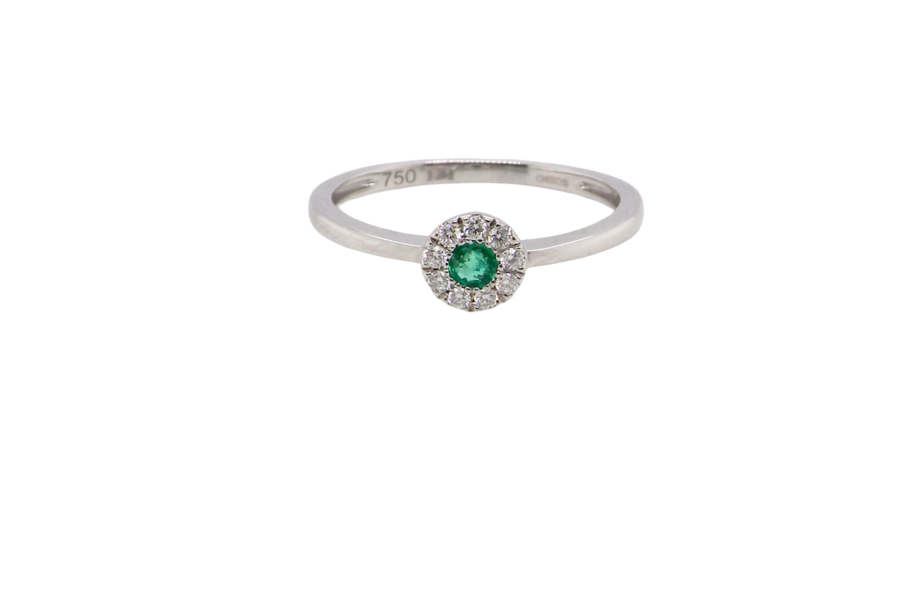 A mini cluster fashioned in 18 carat white gold. The round emerald measures 2.7mm (0.05 carats) 