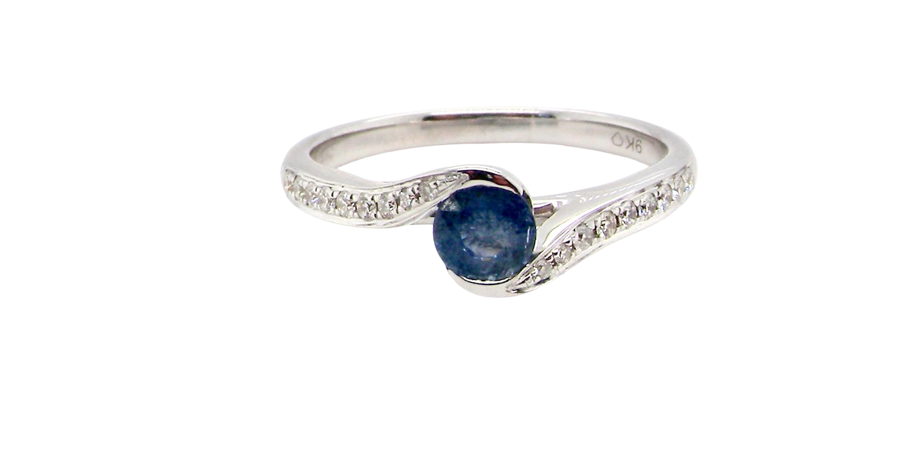 A modern Sapphire and Diamond by-pass ring