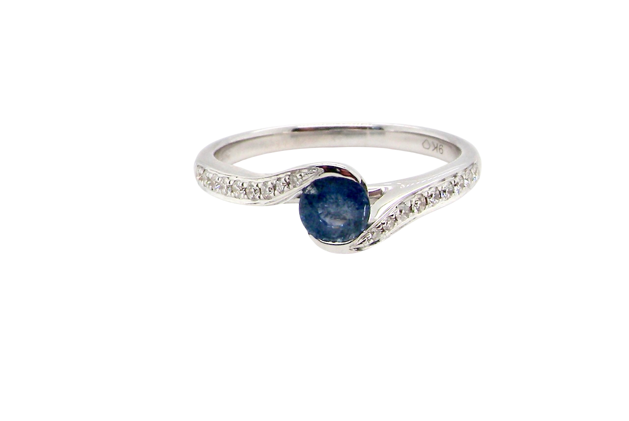A modern Sapphire and Diamond by-pass ring