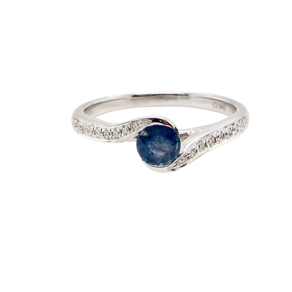 A modern Sapphire and Diamond by-pass ring