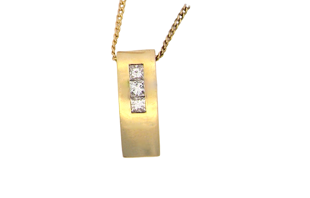 A modern block style pendant. Measures 17x6.3mm. Set with three princess cut white diamonds, close set, each measures 2.75-2.85mm