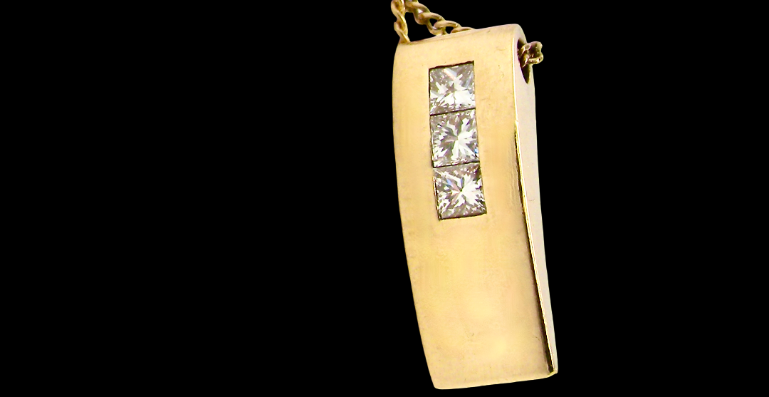 side view A modern block style pendant. Measures 17x6.3mm. Set with three princess cut white diamonds, close set, each measures 2.75-2.85mm (total est 0.40 carats). 