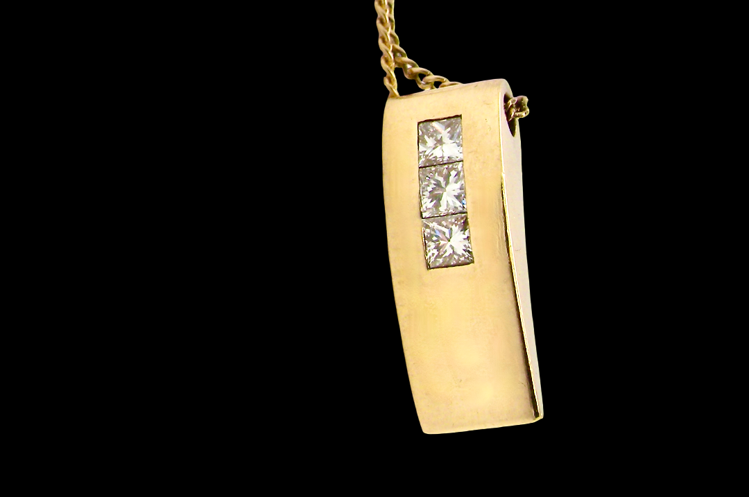 side view A modern block style pendant. Measures 17x6.3mm. Set with three princess cut white diamonds, close set, each measures 2.75-2.85mm (total est 0.40 carats). 