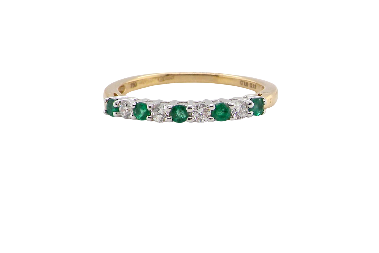 An 18 carat gold Emerald and Diamond eternity ring
