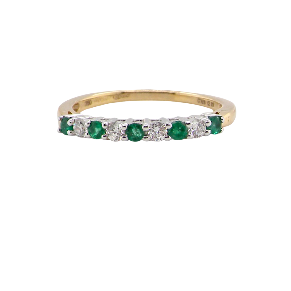 An 18 carat gold Emerald and Diamond eternity ring