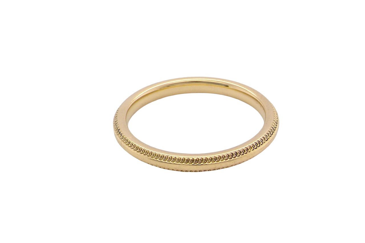 A narrow 18 carat gold wedding ring bead design