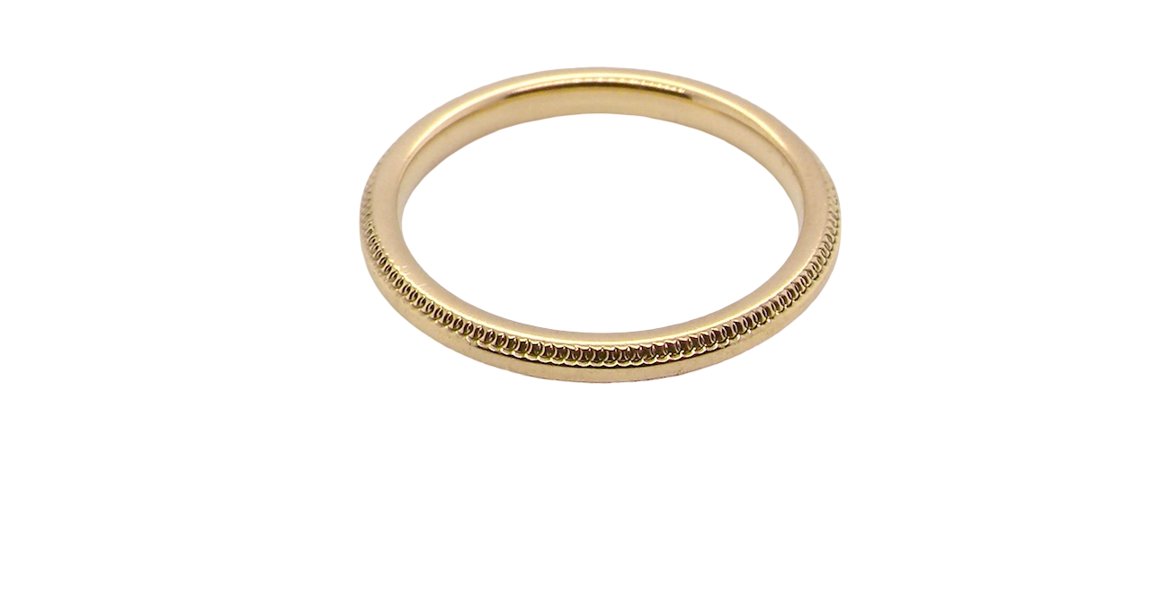A narrow 18 carat gold wedding ring bead pattern