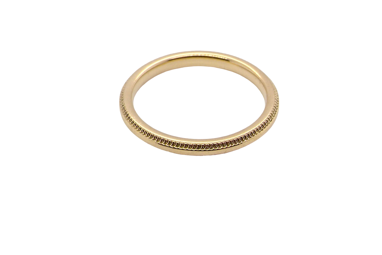 A narrow 18 carat gold wedding ring bead pattern